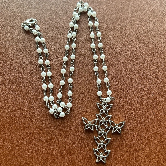 Silver and white cross‎ necklace 24”  in length. Cross is made of butterflies. - Picture 1 of 2